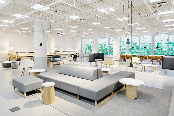 UPF atrium with glass walls, red brick flooring, and natural light from a geometric glass ceiling.